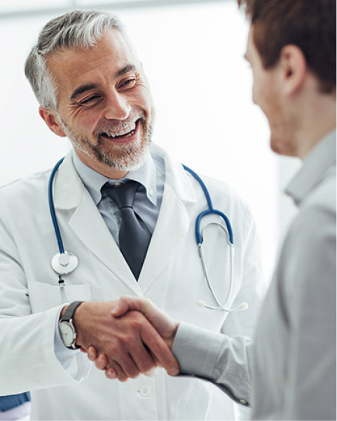 Confident doctor shaking patient's hand